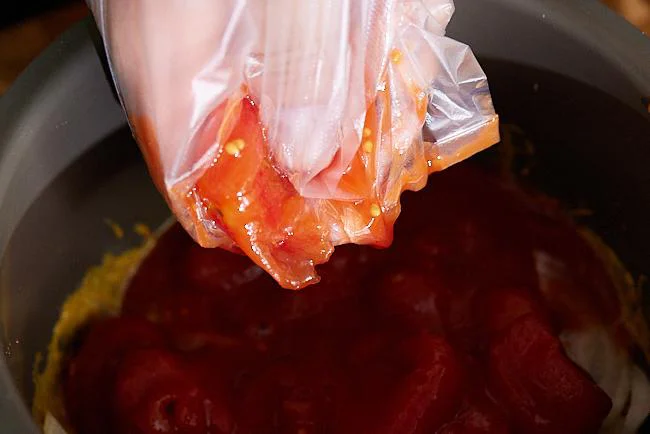 トマトの果肉を手で揉みつぶす