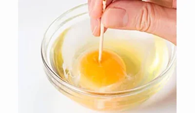  【卵黄に穴をあける】加熱中に卵黄が破裂しないように、卵黄の中央に竹串をさして穴を1カ所あける。