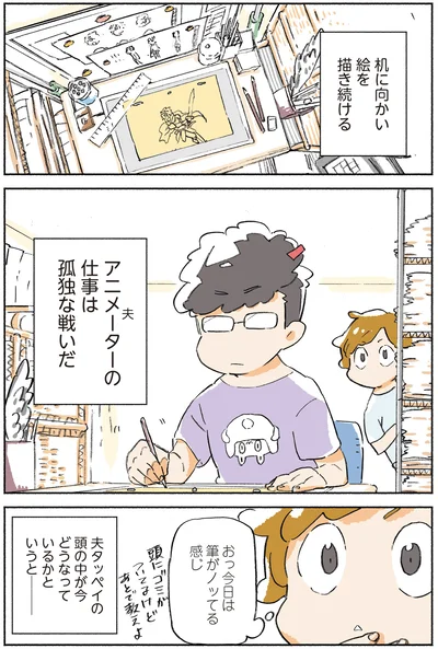 机に向かい絵を描き続ける