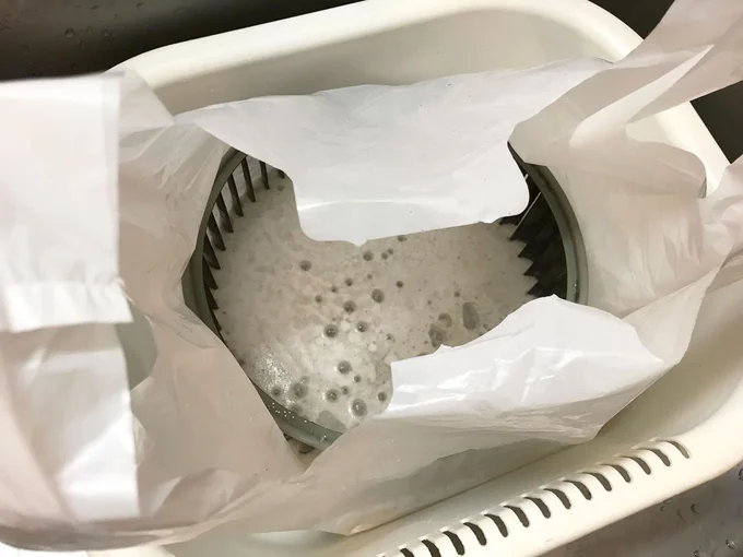 二重にしたビニル袋の中に、50℃程度のお湯を入れてオキシクリーンを溶かします。そこに換気扇を漬けおくだけです