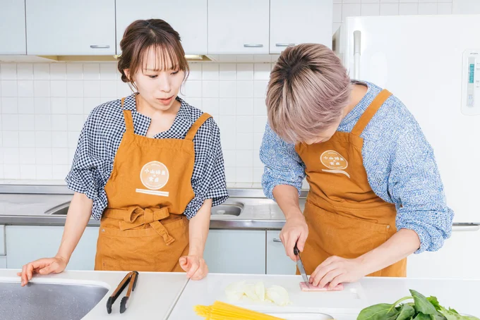 玉ねぎ、ベーコンをカットする小山さん