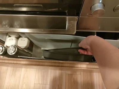 本間さんのお宅では、オーブン下の引き出しを10cmほど開くと、フライパンや塩コショウ、洗剤が取れるようになっています。