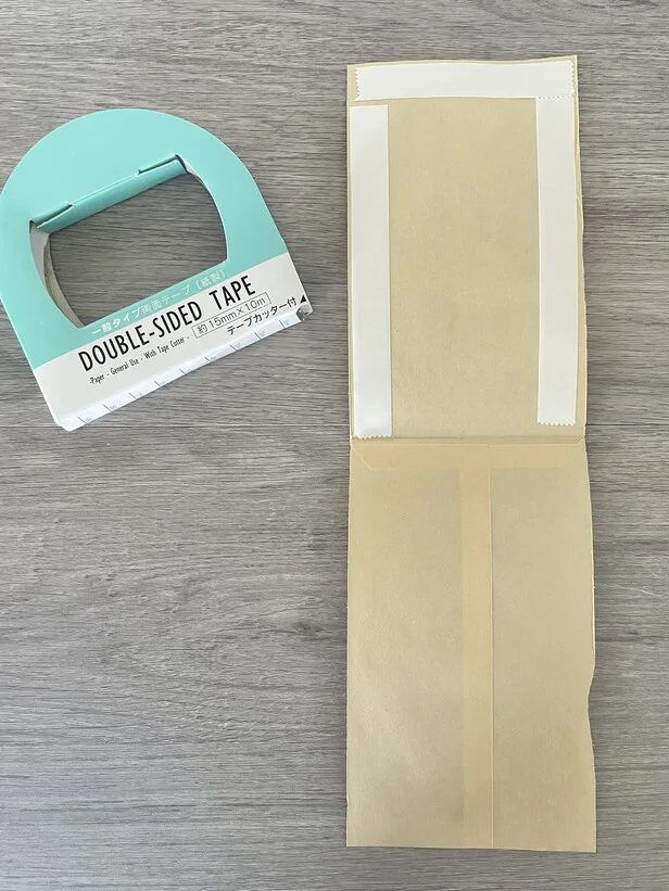 茶封筒の上部と両サイドに両面テープを貼る（▶次へ）