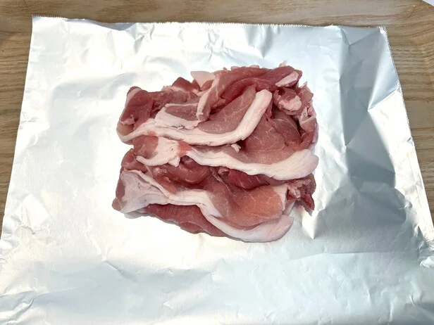 アルミホイルを敷き、中心に肉を置きます（▶次へ）