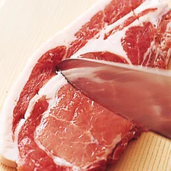 赤身と白い脂身の間に筋があるので、焼いたときに肉が縮んでかたくならないように、切り目を入れておく。