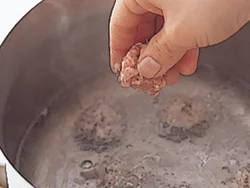 水が沸騰したらひき肉だねを片手で一口大にまとめて落とし入れる。ひき肉のうまみで、おいしいスープになる。