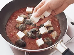 トマトソースをしっかりめの味にととのえてから、豆腐とあさりを加える。