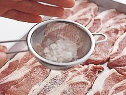 肉にたれがよくなじむように、茶こしを使って、薄くまんべんなく粉をふる。