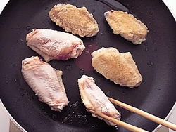 粉をはたいた手羽先は、きつね色にこうばしく焼きつけてから煮ると、短時間で味がからみやすい。