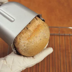 パンケースの底を片手で持ち、もう片方の手をパンに添えるようにして取り出す。パンの山をつぶさないようにして。