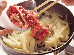 玉ねぎとじゃがいもをしっかり炒めて牛肉を加える。玉ねぎの甘みを生かして塩、こしょうのみのシンプルな味に。