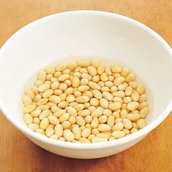 大豆は塩水に一晩つけることで、水分を含んでふくらむ。大豆の水煮缶よりも少しかためになるので混ぜても形がくずれない。