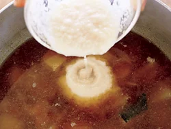 酒粕はそのまま加えるとだまになって溶け切らない。煮汁で少しふやかしてから溶いて加え、混ぜる。