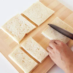 【切り分けた幅が台の高さに】 パンの幅が、でき上がりのケーキの高さになるのできれいな長方形に切る。厚切りのパンだと巻きづらいので、８枚切りがおすすめ。