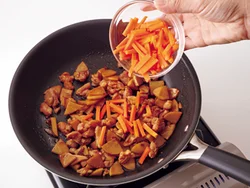 具を炒めてから炊き込む。にんじんは細切りなので、炒め時間を短くすると炊飯中にくずれにくい。