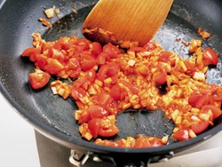 トマトとキムチをトマトが少しくずれるくらいまでさっと炒め合わせ、フレッシュな食感を残す。