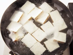 豆腐は水から入れて、煮立ったら取り出す。余分な水けが抜け、炒めやすくなる。