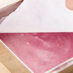 型に流し入れると、表面に気泡ができるが、オーブン用ペーパーをのせてはがせば泡がきれいに消える。