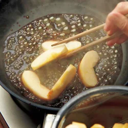 グツグツ煮詰まって濃い茶色になったら、りんごを静かに加える。